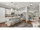 Bright kitchen features white cabinetry, quartz countertops, stainless appliances and a breakfast bar at 3592 Parkhaven Pl, Brookhaven, GA 30319
