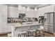 Bright kitchen features white cabinetry, quartz countertops, stainless appliances and a breakfast bar at 3592 Parkhaven Pl, Brookhaven, GA 30319