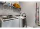 Practical laundry room equipped with a washer, dryer, storage, and hanging rack at 3592 Parkhaven Pl, Brookhaven, GA 30319