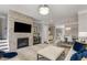 Cozy living room with fireplace, tv and open floor plan to dining area at 3592 Parkhaven Pl, Brookhaven, GA 30319