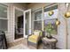 Cozy covered patio with wicker furniture, perfect for relaxing outdoors with a view into the home at 3592 Parkhaven Pl, Brookhaven, GA 30319