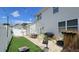Landscaped backyard with patio, turf, cornhole, and white privacy fence at 3811 Holliwell Pass, Cumming, GA 30040
