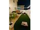 Night view of backyard featuring artificial turf, patio, and cornhole setup at 3811 Holliwell Pass, Cumming, GA 30040