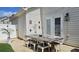Charming backyard dining area with string lights, privacy fence, and brick patio at 3811 Holliwell Pass, Cumming, GA 30040