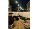 Night view of landscaped backyard with manicured artificial turf and privacy fence at 3811 Holliwell Pass, Cumming, GA 30040