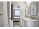 Bathroom with a double sink vanity, decorative mirrors and an open doorway to a bedroom space at 3811 Holliwell Pass, Cumming, GA 30040
