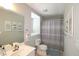 Bathroom showcasing a vanity with sink, toilet and bathtub with gray diamond patterened curtain at 3811 Holliwell Pass, Cumming, GA 30040