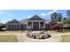Community clubhouse with circular driveway and manicured landscaping, creating an inviting gathering space at 3811 Holliwell Pass, Cumming, GA 30040