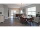 Sunlit dining room featuring hardwood floors, and a view of the kitchen area at 3811 Holliwell Pass, Cumming, GA 30040