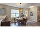 Inviting dining room features a wooden table set, chandelier lighting, and a large window overlooking the exterior at 3811 Holliwell Pass, Cumming, GA 30040