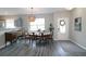 Sunlit dining room featuring hardwood floors, a stylish chandelier, and a view of the entrance at 3811 Holliwell Pass, Cumming, GA 30040