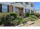 Charming entrance with stone facade, blossoming shrubs, and a walkway leading to the front door at 3811 Holliwell Pass, Cumming, GA 30040
