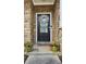 Close up of front entrance with a wreath, potted plants, and a stone facade at 3811 Holliwell Pass, Cumming, GA 30040
