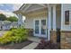 Charming home entrance with double doors, landscaped garden, and stone accents at 3811 Holliwell Pass, Cumming, GA 30040
