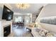 Open living area featuring a fireplace, hardwood floors, white trim, and easy access to the dining room at 3811 Holliwell Pass, Cumming, GA 30040