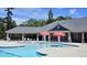 Community pool with mushroom fountains, lounge chairs, and shaded areas, perfect for Gathering fun at 3811 Holliwell Pass, Cumming, GA 30040