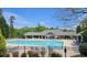 Community pool with lounge chairs and sun umbrellas surrounded by trees, perfect for summer relaxation at 3811 Holliwell Pass, Cumming, GA 30040