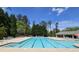 Large community pool with lounge chairs, surrounded by lush trees, ideal for summer relaxation and fun at 3811 Holliwell Pass, Cumming, GA 30040