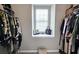 Organized walk-in closet featuring shelves and hanging rods for ample storage and a window for natural light at 3811 Holliwell Pass, Cumming, GA 30040