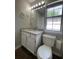 Bathroom featuring a white vanity with granite countertop and a window for natural light at 4081 Liberty Hill Dr, Norcross, GA 30093