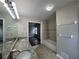 Bathroom featuring double sinks with granite countertops, tub and shelving at 4081 Liberty Hill Dr, Norcross, GA 30093