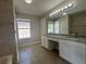Bathroom with double vanity, tile floor, and large mirror, offering a clean and functional space at 4081 Liberty Hill Dr, Norcross, GA 30093