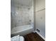 Bathroom showcasing tiled shower and tub with modern fixtures and a marble surround at 4081 Liberty Hill Dr, Norcross, GA 30093