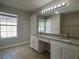 Bright bathroom featuring double sinks with granite countertops and a large mirror at 4081 Liberty Hill Dr, Norcross, GA 30093