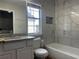 Bathroom with white cabinets, granite countertops, new tub and shower with tile surround at 4081 Liberty Hill Dr, Norcross, GA 30093