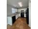 Well-lit kitchen featuring updated countertops, black appliances, white cabinets, and tile flooring at 4081 Liberty Hill Dr, Norcross, GA 30093