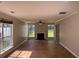 Bright living room featuring a fireplace, neutral walls, and large windows that provide abundant natural light at 4081 Liberty Hill Dr, Norcross, GA 30093