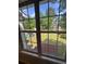 View from a window of a green backyard with a playset visible beyond a lawn at 955 Tributary Way, Dacula, GA 30019
