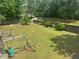Fenced backyard with swing set and lush green grass at 955 Tributary Way, Dacula, GA 30019