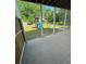 View of backyard featuring playset and swing from covered porch at 955 Tributary Way, Dacula, GA 30019