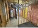 Unfinished basement featuring pink and yellow insulation, plumbing, and electrical systems at 955 Tributary Way, Dacula, GA 30019