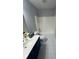 Bathroom features a large mirror, vanity with storage, and shower over tub at 955 Tributary Way, Dacula, GA 30019