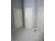 Tiled bathroom with three white doors and decorative tiling along the trim at 955 Tributary Way, Dacula, GA 30019