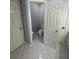 Tiled bathroom with three white doors including a door to an enclosed toilet at 955 Tributary Way, Dacula, GA 30019