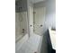 Bathroom with white tile flooring and shower/tub combo at 955 Tributary Way, Dacula, GA 30019