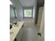 Bathroom showcasing double sinks, large soaking tub, and separate shower with natural light at 955 Tributary Way, Dacula, GA 30019