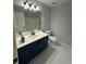 Bathroom features blue vanity and white tile floors at 955 Tributary Way, Dacula, GA 30019