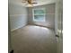 Bedroom with neutral walls and light-colored carpet, featuring a ceiling fan and natural light at 955 Tributary Way, Dacula, GA 30019