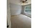 A well-lit bedroom features neutral carpeting and a ceiling fan at 955 Tributary Way, Dacula, GA 30019