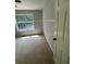 Bright bedroom featuring a large window and neutral carpeting at 955 Tributary Way, Dacula, GA 30019