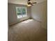 Bedroom with natural light from the window and a ceiling fan at 955 Tributary Way, Dacula, GA 30019