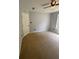 Bedroom featuring neutral carpet, fan, window with a view, and closet at 955 Tributary Way, Dacula, GA 30019