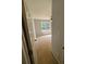View into a bedroom with neutral walls and carpet, featuring a ceiling fan and natural light at 955 Tributary Way, Dacula, GA 30019