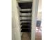 Custom closet features dark-stained wood shelves for ample storage at 955 Tributary Way, Dacula, GA 30019