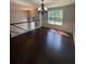 Dining room with hardwood floors, wainscoting, and modern chandelier at 955 Tributary Way, Dacula, GA 30019