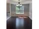 Formal dining room featuring hardwood floors, modern chandelier, and natural light at 955 Tributary Way, Dacula, GA 30019